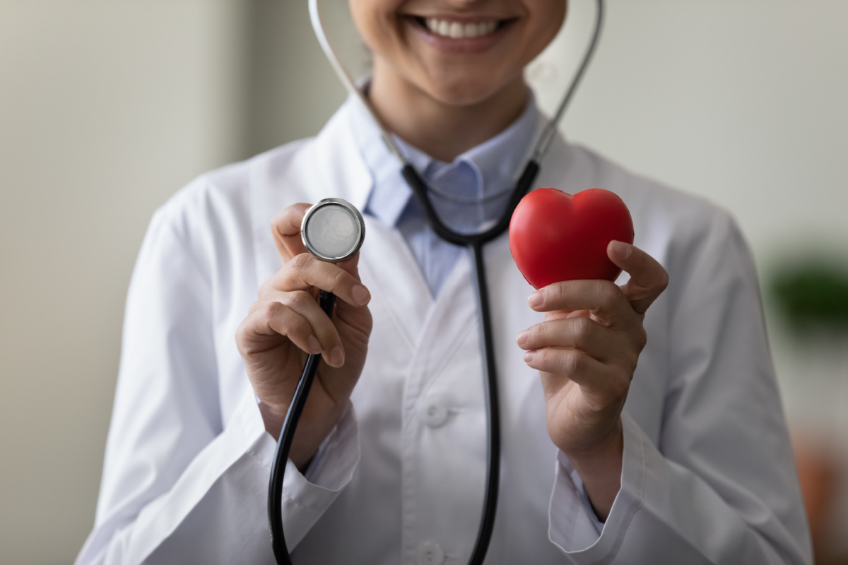Doctor holding stethoscope and red heart
